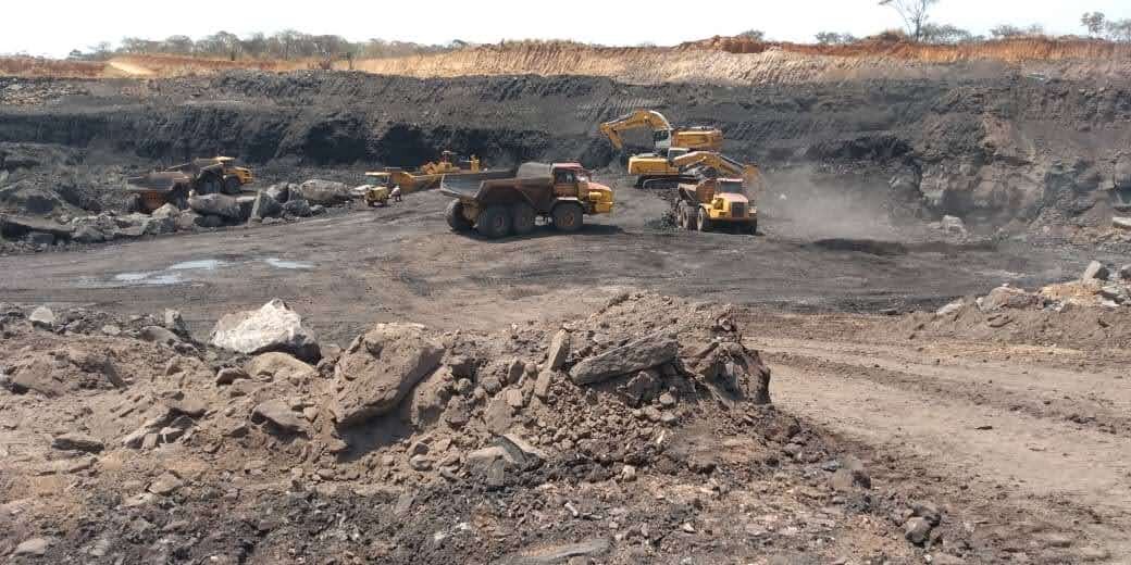 Heavy equipment working across an open operational site