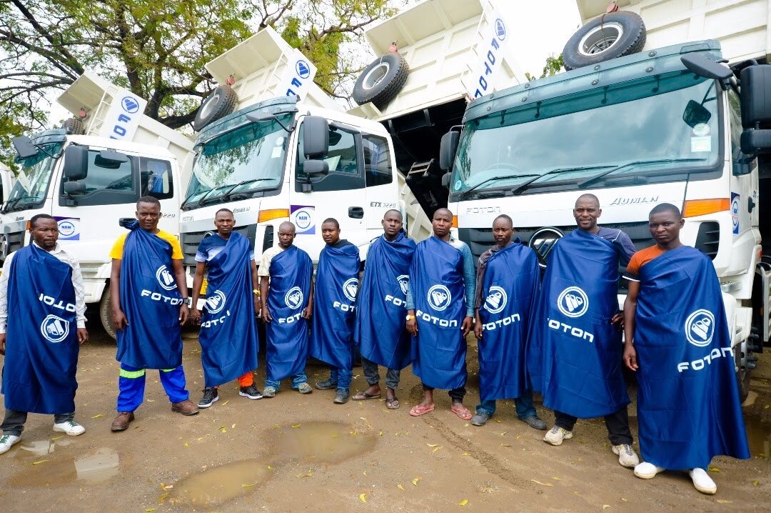 NAM team members standing in front of company trucks